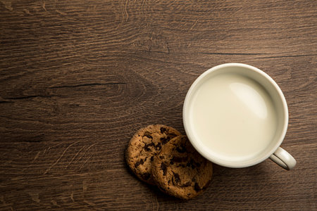 delicious hot cup of milk , breakfast  on old wooden table