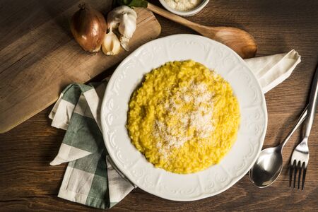 delicius Italian risotto rice with saffron on wooden backgroundの写真素材