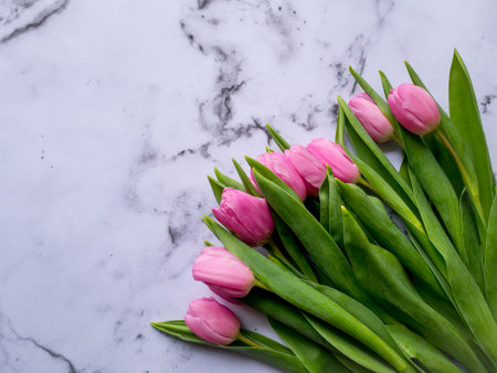 Bunch of pink tulips on a marble table. Flat lay. Landscape format.の写真素材