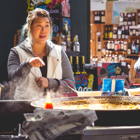 Young tourist at a Spanish food stall in Borough Market. London, 2017.のeditorial素材