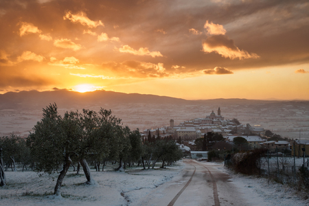 A view of Trevi in Umbria (Italy) at sunset with snow. Landscape format.の写真素材