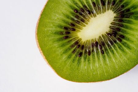 Portion of a slice of kiwi isolated on white background, top view, landscape format. Close-up.の写真素材