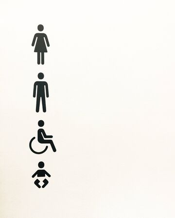 Black toilet signs on a white background (male, female, wheelchair and baby).の写真素材