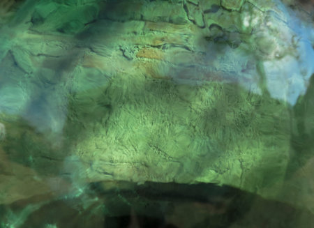 image of a wall of a historic Tuscan house taken on a sunny day through a deforming green glass