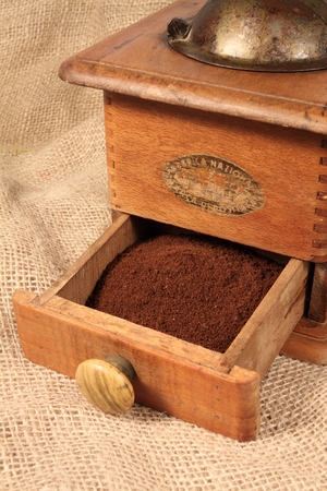Old grinder with ground coffeeの写真素材