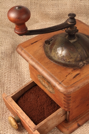 Old grinder with ground coffeeの写真素材