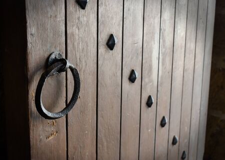 old wooden door with iron handleの写真素材
