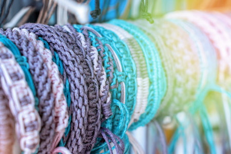 Braided handmade leather bracelets in sunlight, toned