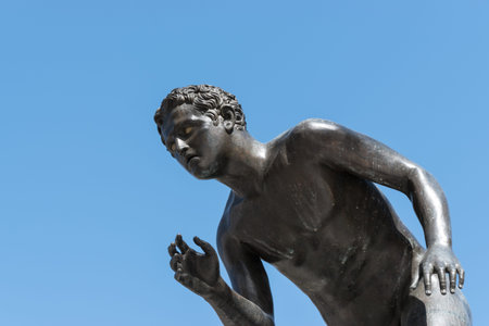 Black metal or bronze statue of a boy.の写真素材