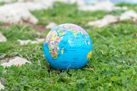 Small globe in the grass. Travel and global issues concept.