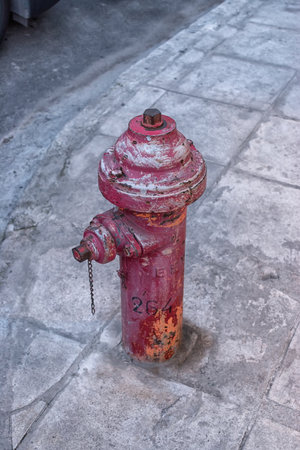 Red rusty antique fire hydrant on the street.の写真素材