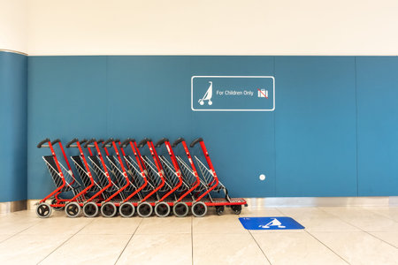 Empty trolleys for children in airport.