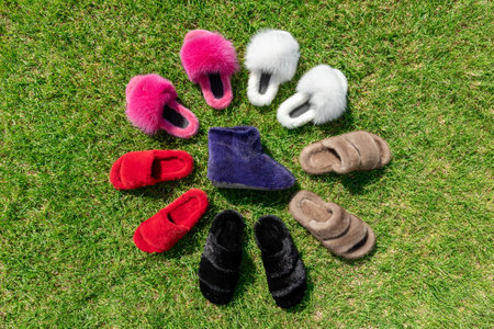 Beautiful fur footwear on a green grass. Flat lay.の写真素材