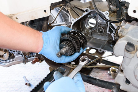 Hand with tools, Professional mechanic repair and modifications to ATV