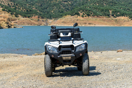 ATV offroad on mountain and sky background.