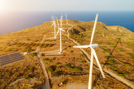 Wind turbines on beautiful sunny mountain landscape. Green power generation concept.の写真素材