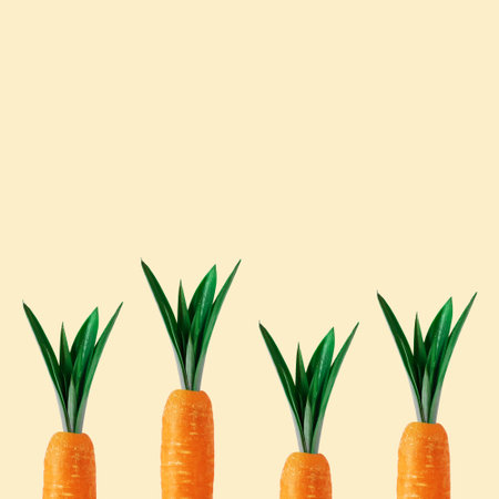 Carrot with pineapple leaves on pastel yellow background. Minimal spring composition.の写真素材