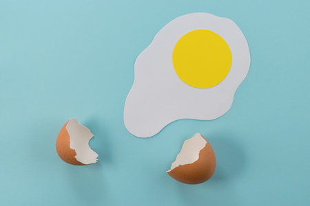 Paper fried egg with broken egg shell.