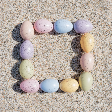 Colorful Easter eggs on the beach in sunny day. Easter concept.