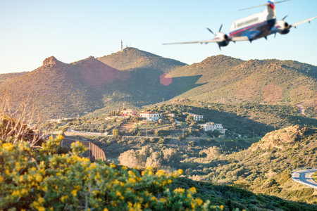 Blurred silhouette of airplane flying over the mountains. Travel concept.の写真素材