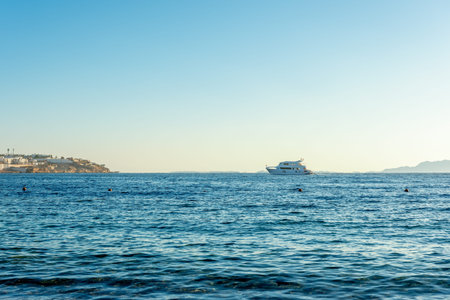 Pleasure yacht on the sea surface on a sky background.