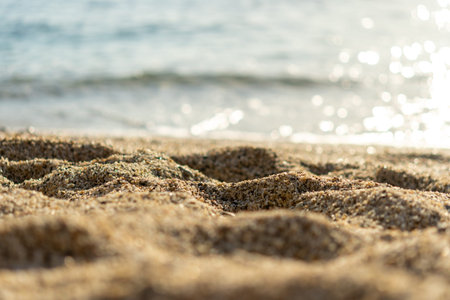 Beach sand on sea background. Summer vacation background. Selective focus.