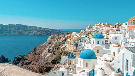 View of Oia town with traditional and famous houses and churches with blue domes over the Caldera on Santorini island. Greece.の写真素材