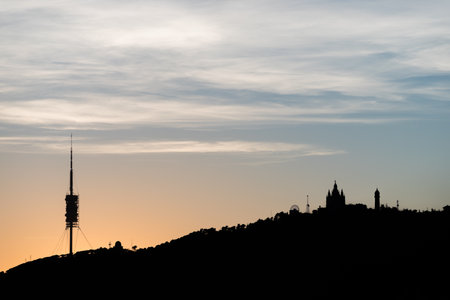 Silhouette of Tibidabo hill at the sunset in Barcelona city. Spain.の写真素材