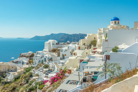 View of Oia town with traditional and famous houses and churches with blue domes over the Caldera on Santorini island. Greece.の写真素材