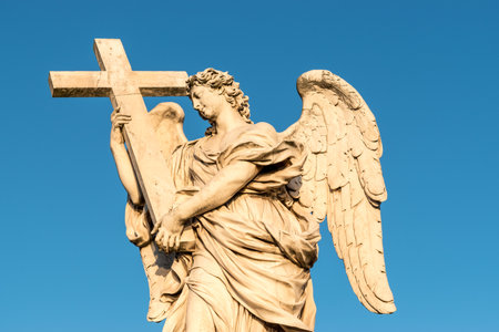 Marble statue of angel with cross. Saint Angelo Bridge in Rome. Italy.の写真素材