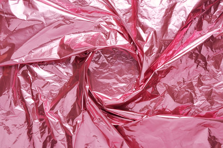 Abstract pink crumpled foil background. Minimal party concept.の写真素材