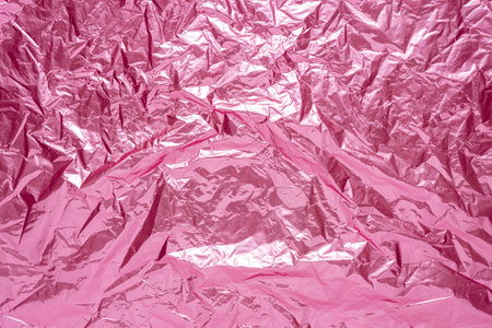 Abstract pink crumpled foil background. Minimal party concept.の写真素材