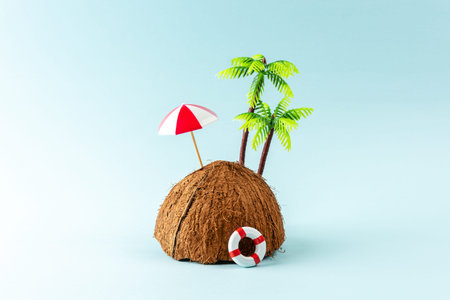 Creative background with coconut fruit and palm tree on pastel blue background. Summer holiday...
