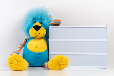 Empty lightbox with lion toy on white table. Mockup concept.の写真素材