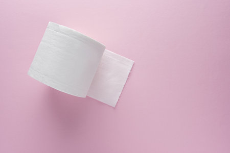 Creative layout of toilet paper roll on pink background.の写真素材