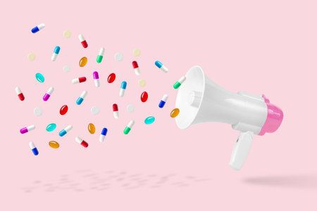 Medicine background made of white-pink megaphone and colorful pills. Minimal epidemic virus concept.の写真素材
