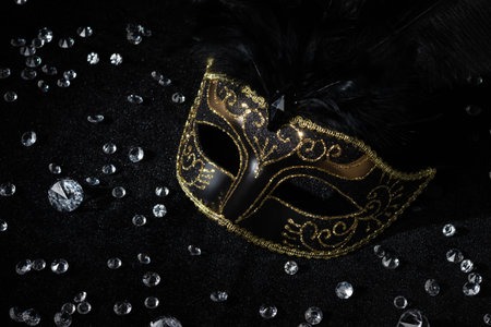 Close-up view of Carnival gold mask with diamonds on black background.の写真素材