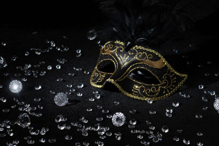 Masquerade gold mask with gemstones on black background.の写真素材