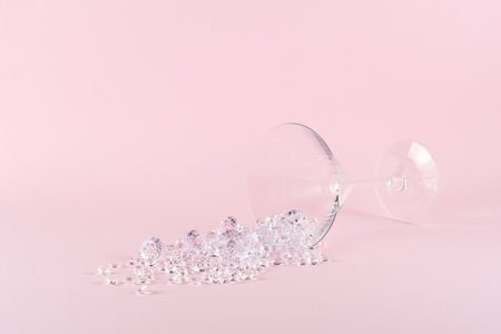 Creative layout made of martini cocktail glass with diamonds on pastel pink background. Minimal party concept.の写真素材