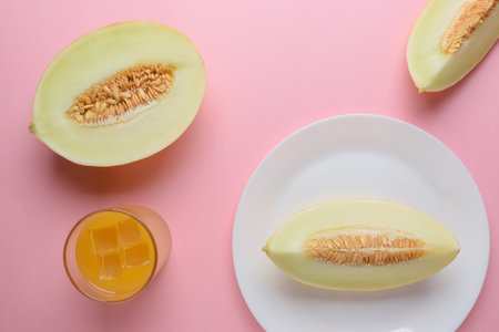 Melon sliced on pastel pink background. Minimal fruit concept.の写真素材
