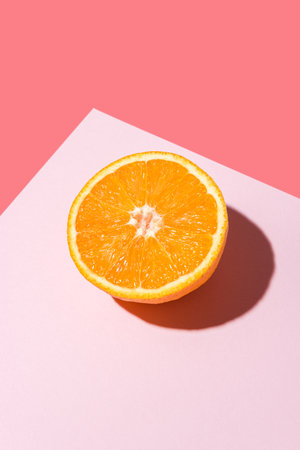 Creative fruit composition on pink background with hard shadows. Summer minimal concept.の写真素材