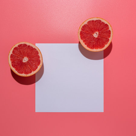 Creative fruit composition on pink background with hard shadows. Summer minimal concept.の写真素材