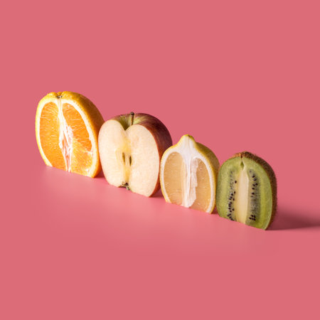 Creative composition with sliced fruits on pink background. Summer minimal concept.の写真素材