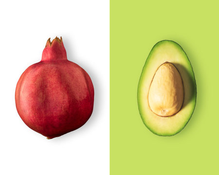 Creative layout made of pomegranate and avocado. Flat lay. Food vegan concept.
