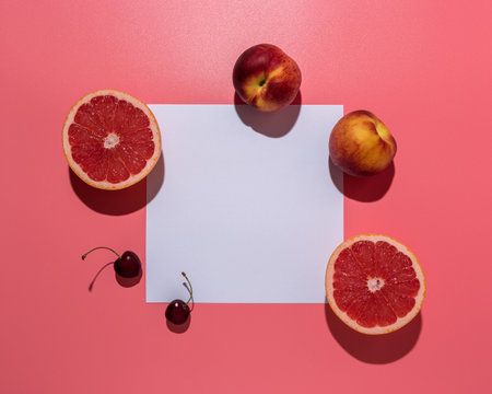 Creative fruit composition on pink background with hard shadows. Summer minimal concept.の写真素材