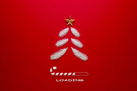 Christmas tree and candy cane on red background. Creative Minimal Christmas Loading Concept.