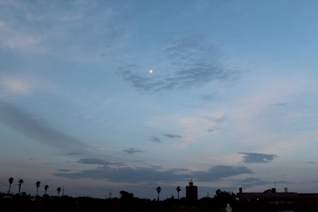The moon in the evening sky over the city of Valencia, Spainの写真素材