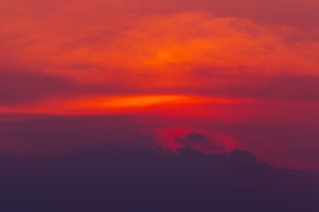 The colorful sky of red Orange and with clouds like mountains are a bright background from natureの写真素材