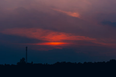 The red-orange clouds of the evening sky at sunset are bright and beautiful as a natural background.