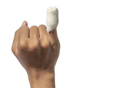 Hand with little finger injury With a white bandage The hand showing the wound with clipping path on a white backgroundの写真素材
